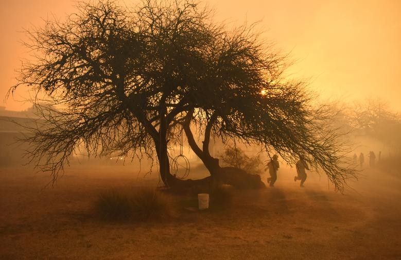 Firefighters work as smoke rises in San Antonio de Arredondo, in Cordoba province, Argentina September 22, 2020. Picture taken September 22, 2020 REUTERS/Charly Soto NO RESALES. NO ARCHIVES TPX IMAGES OF THE DAY